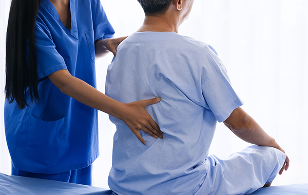 Female-Chiro-touching-lower-back-NF-Chiropractic Female-Chiro-touching-lower-back-NF-Chiropractic