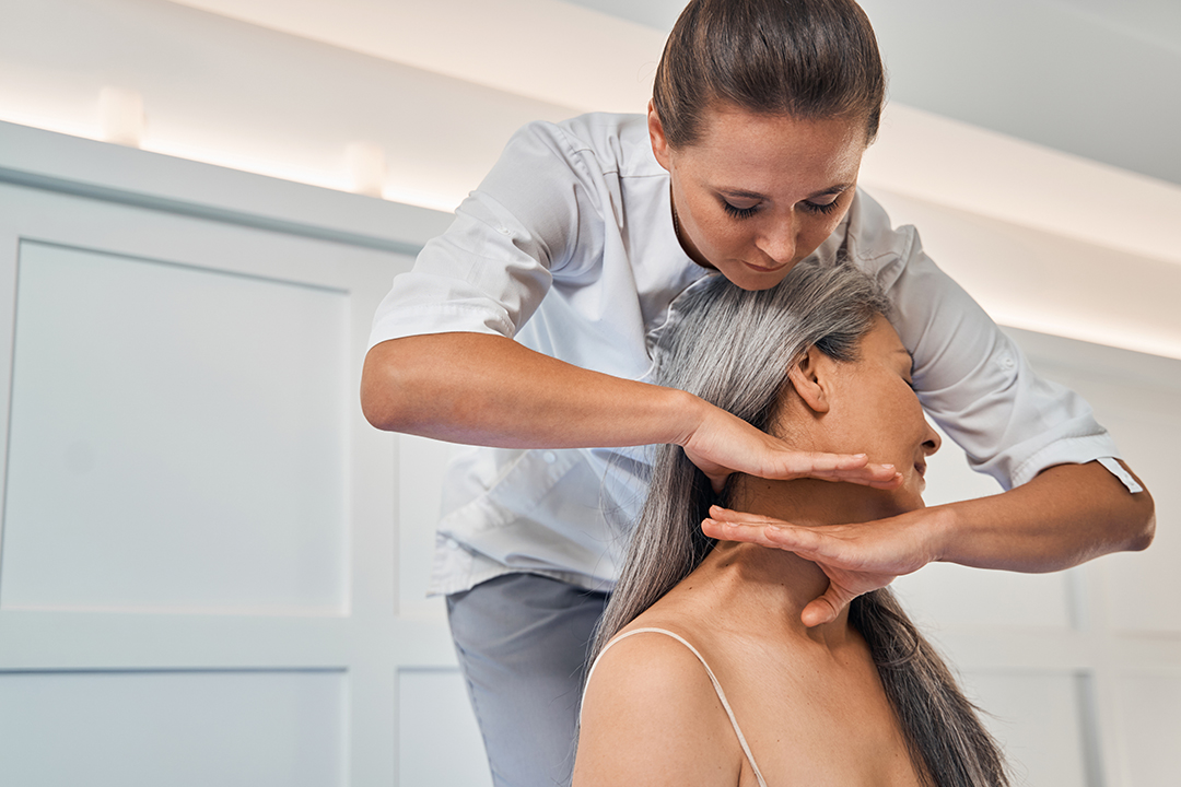 Focused photo on female hands massaging neck Checking Spine for Scoliosis